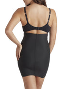 a woman wearing a black tummy control shapewear slip