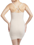 a woman wearing a nude tummy control shaping slip body shaper with criss cross straps