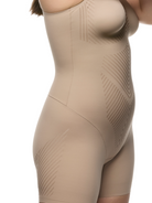 a close up detail shot of woman wearing a black tummy control shapewear bodysuit body shaper