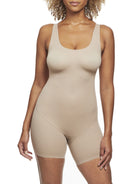 a woman wearing a nude tummy control shapewear bodysuit