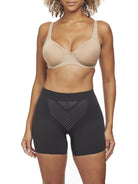 a woman wearing a black tummy control shapewear short