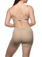 a woman wearing a beige tummy control shapewear short