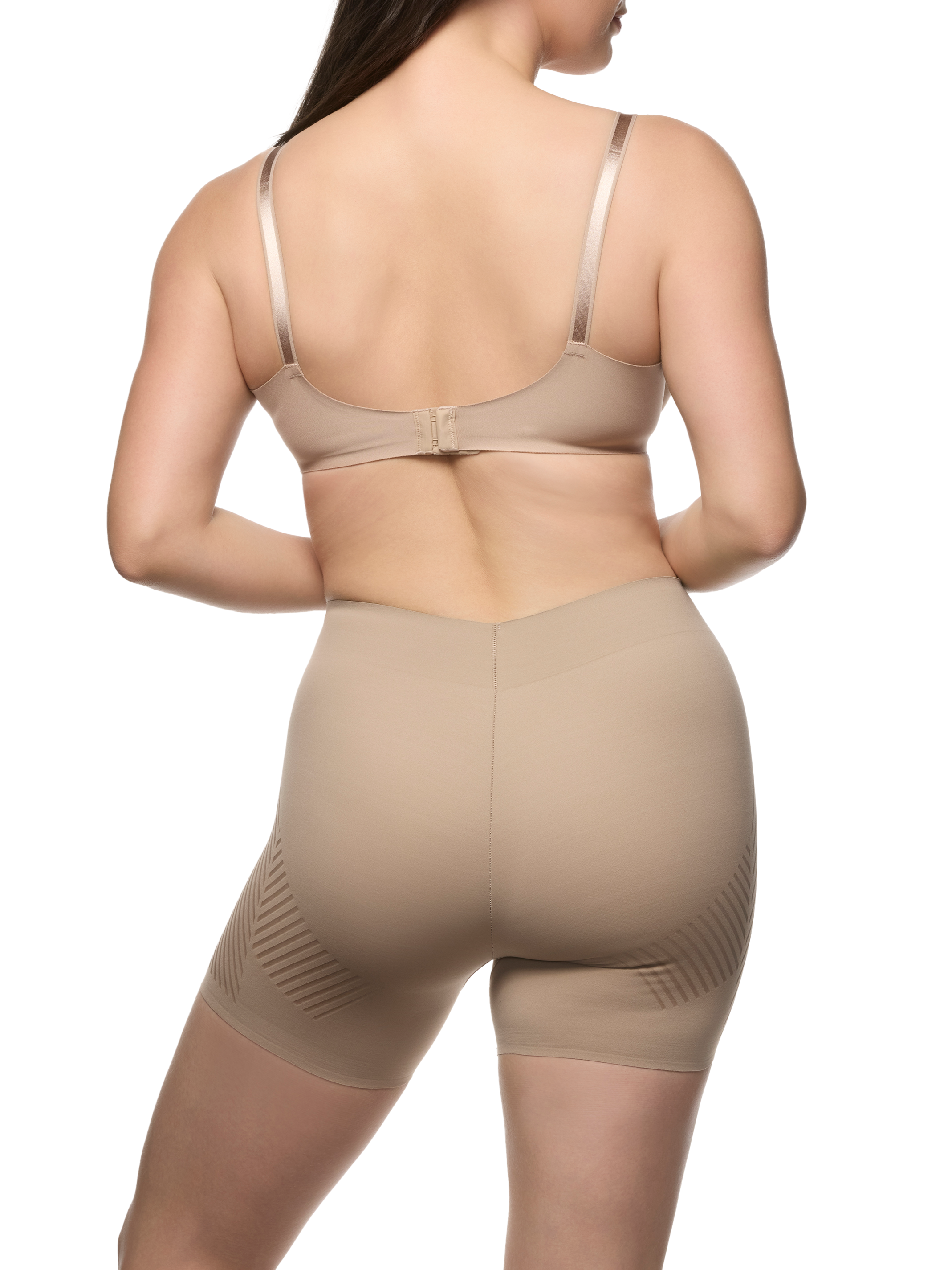 a woman wearing a beige tummy control shapewear short