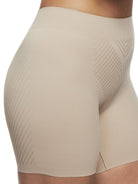 a close-up detail of a woman wearing a nude tummy control shapewear short