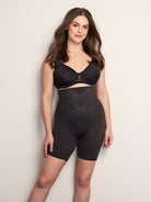 a woman wearing a black high waisted tummy control shapewear short