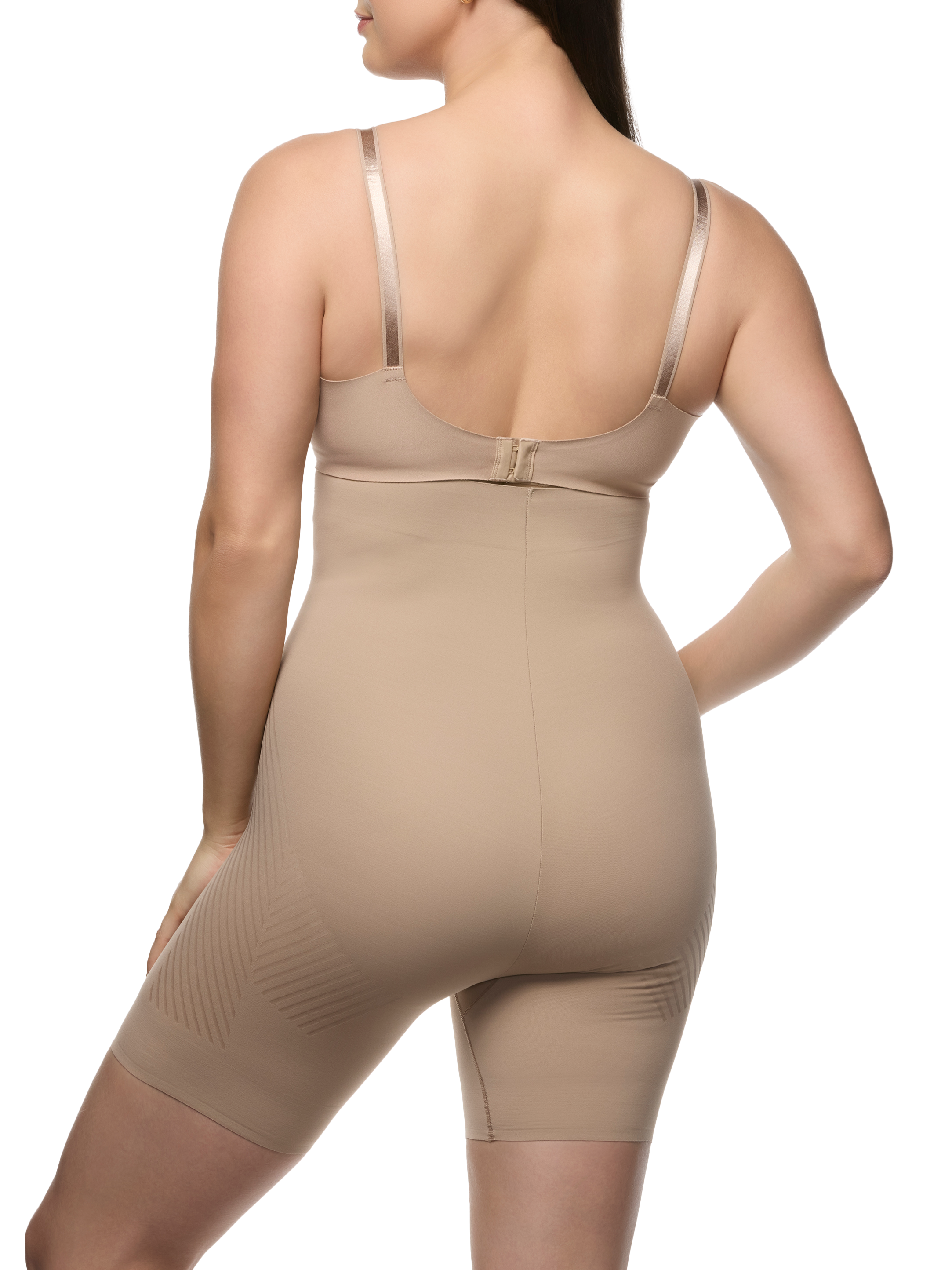 a woman wearing a beige high waisted tummy control shapewear short