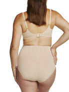 a woman wearing a beige maternity support brief