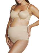 a woman wearing a beige maternity support brief