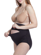 a woman wearing a black maternity shapewear support brief