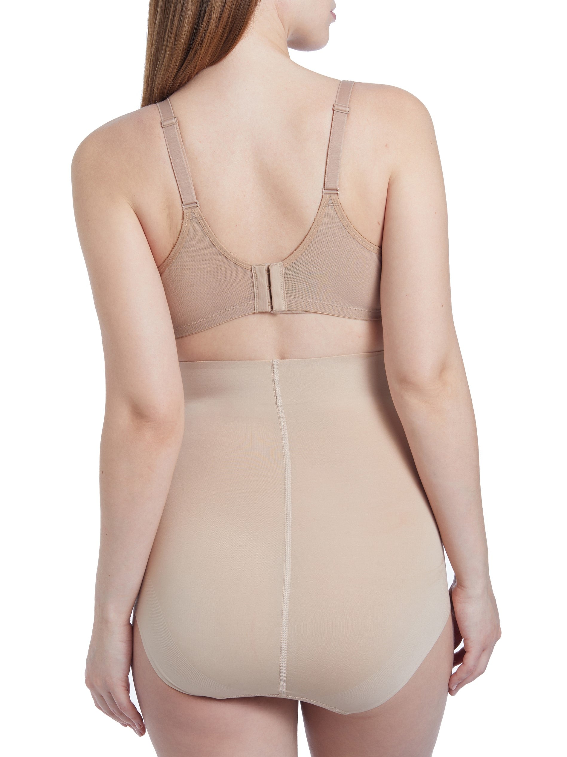 a woman wearing a beige maternity support brief