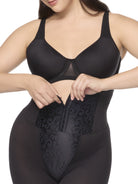 a closeup of a woman wearing a black high waisted tummy control waist cincher shaping short shapewear