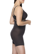 a woman wearing a black high waisted tummy control waist cincher shaping short shapewear