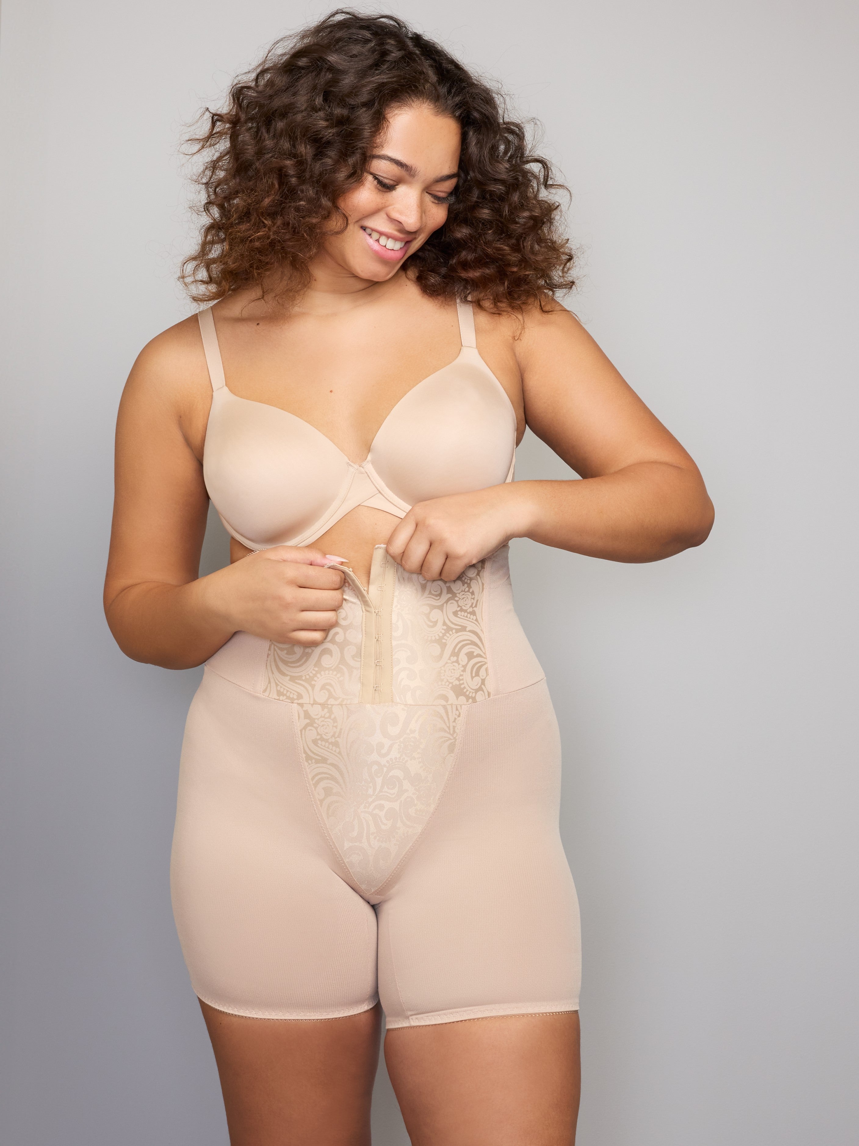 a woman wearing a nude high waisted tummy control waist cincher shaping short shapewear all-groups