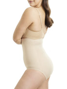 a woman wearing a beige shaping brief