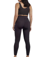 a woman wearing black tummy control leggings shapewear