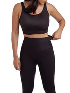 a woman wearing black tummy control leggings shapewear