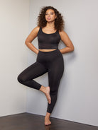 a woman wearing black tummy control leggings shapewear