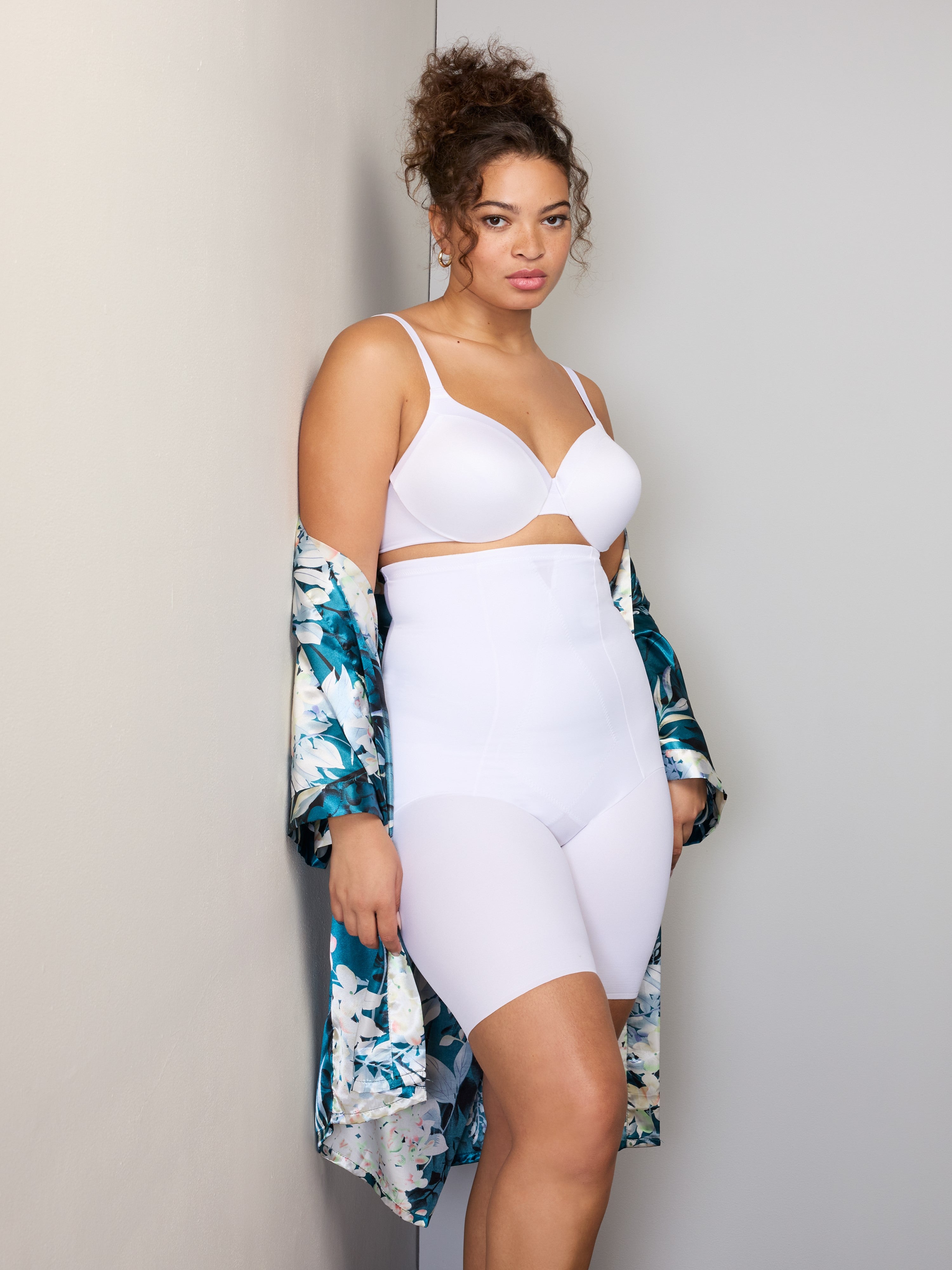 a woman wearing white high waisted tummy control shapewear shorts and a floral robe all-groups