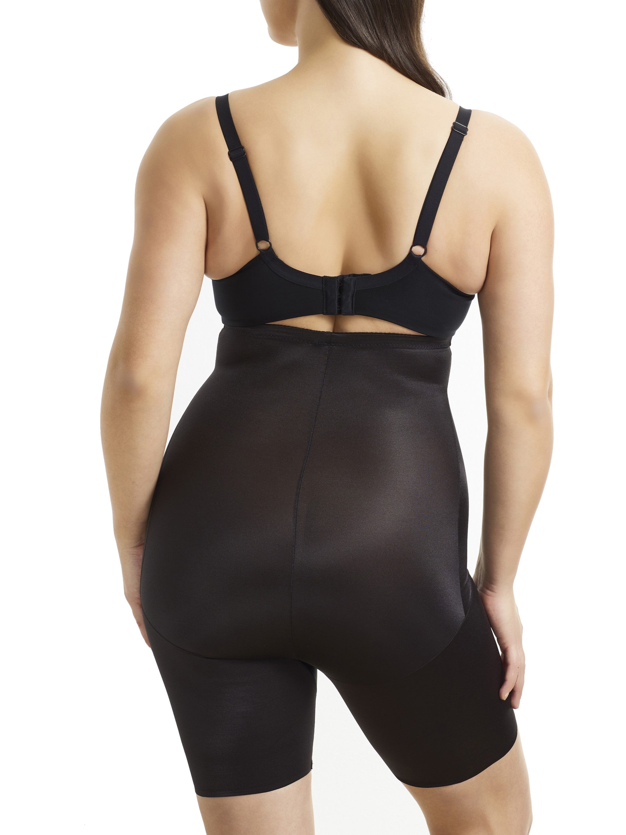 a woman wearing black high waisted tummy control shapewear shorts