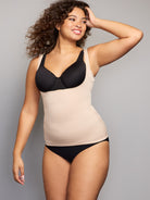 a woman wearing a nude open bust shaping camisole shapewear all-groups