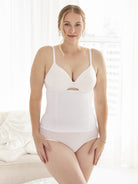 a woman wearing a white waist cincher waist trainer girdle all-groups