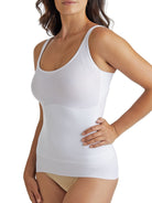 a woman wearing a white shaping camisole tank top shapewear