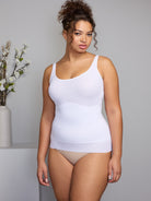 a woman wearing a white shaping camisole tank top shapewear all-groups