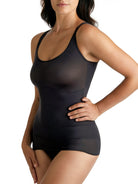 a woman wearing a black shaping camisole tank top shapewear