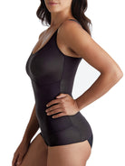 a woman wearing a black shaping camisole tank top shapewear