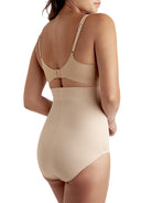 a woman wearing a beige shaping brief