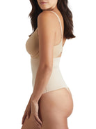 a woman wearing a nude tummy control thong shaper