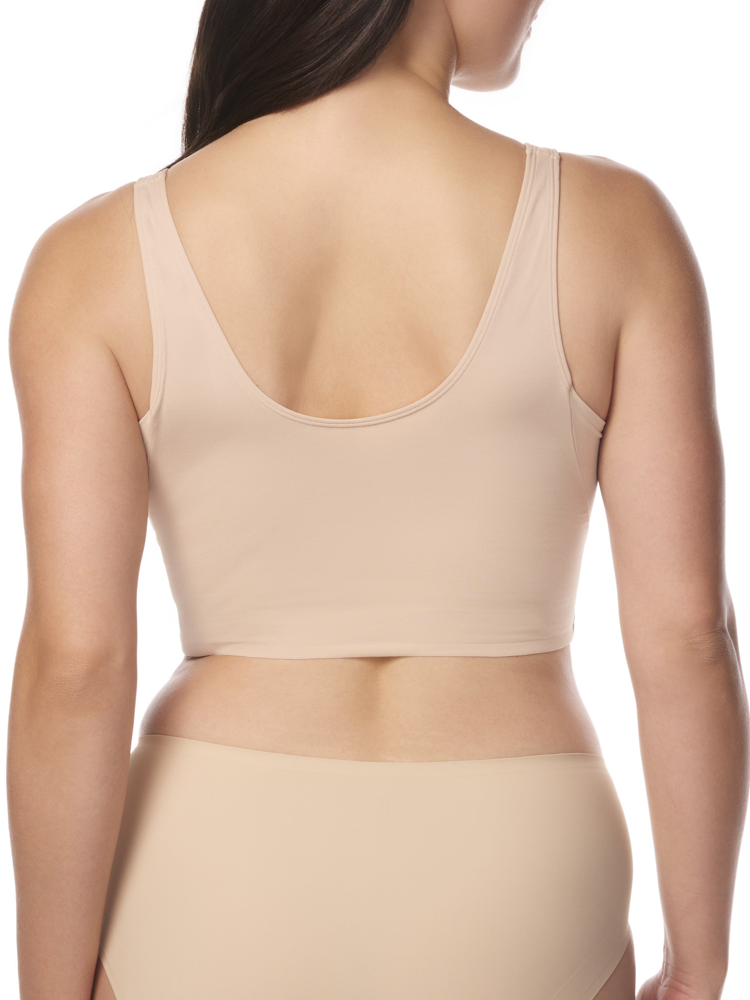 a woman wearing a beige underarm smoothing bralette