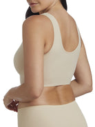 a woman wearing a beige shaping lounge bra