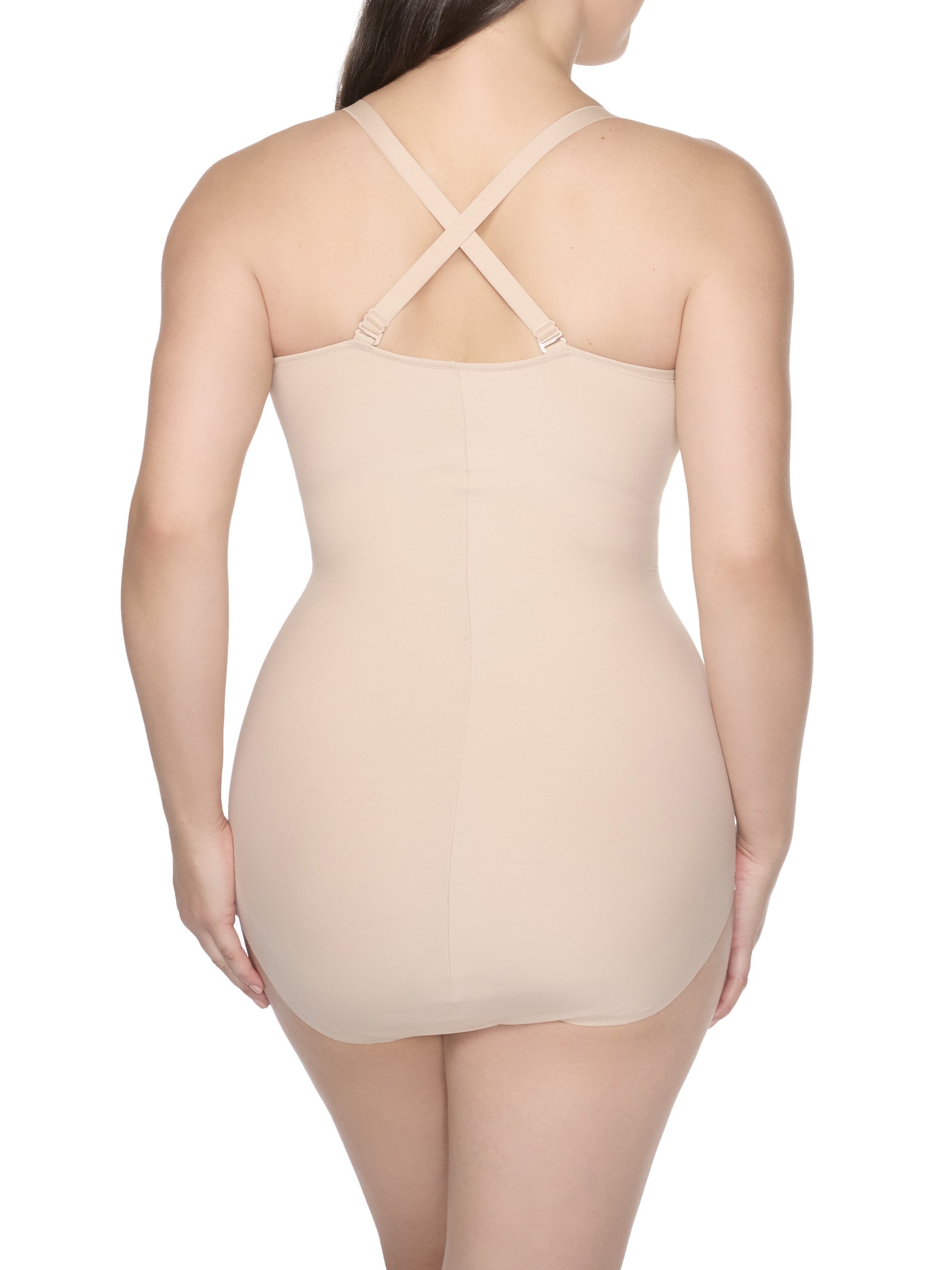 a woman wearing a nude tummy control body shaper shapewear with criss cross straps