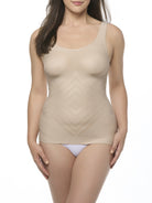 Woman wearing a beige camisole shaper on a white background