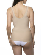Woman wearing a beige camisole shaper on a white background