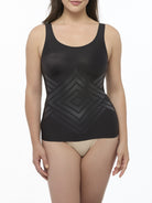 Woman wearing a black camisole shaper on a white background