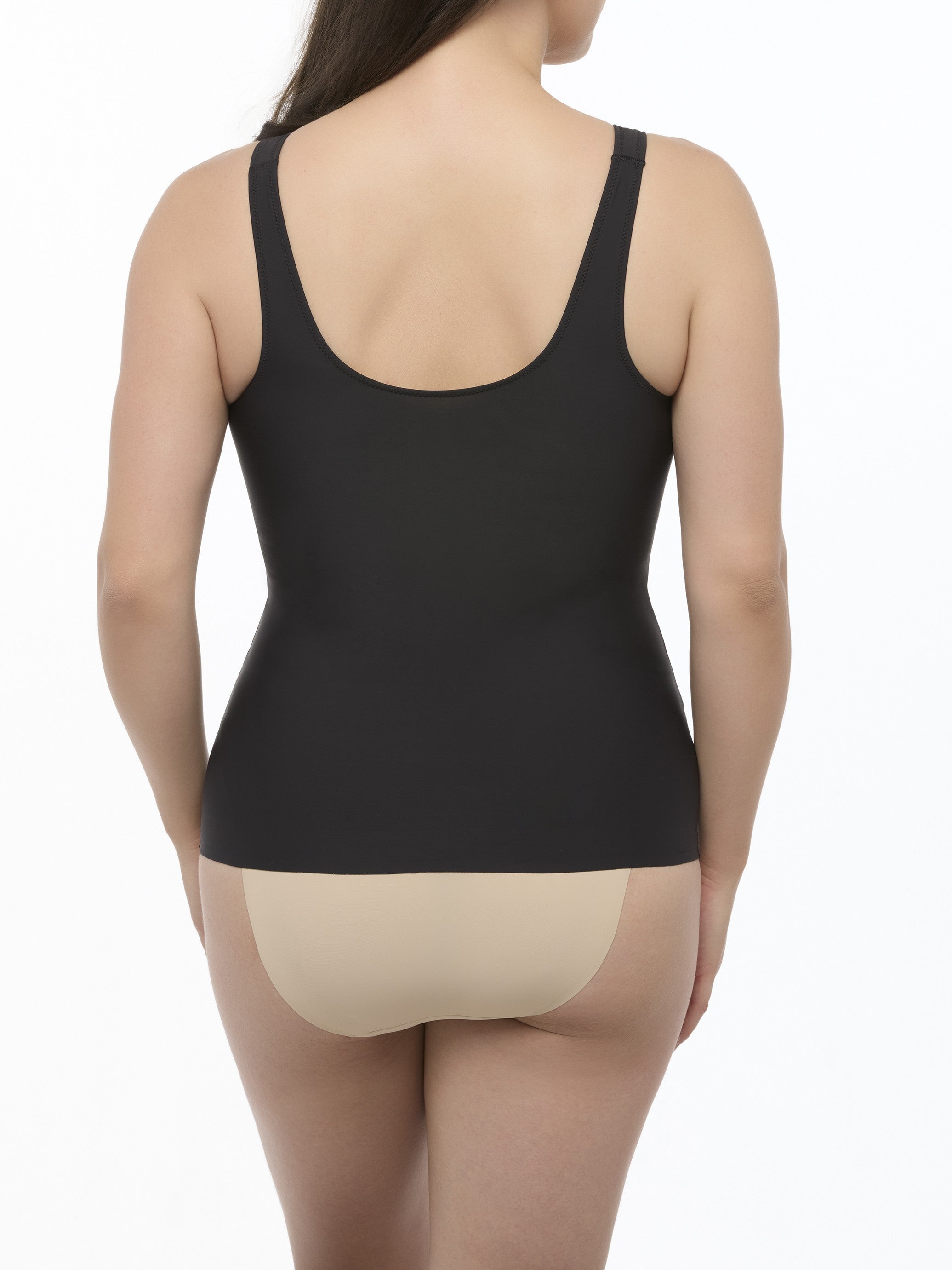 Woman wearing a black camisole shaper on a white background