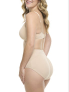 A woman in a beige padded shaping brief on a white background