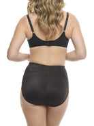 A woman in a beige padded shaping brief on a white background