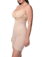 Woman wearing a beige shapewear garment on a white background