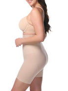 Woman wearing a beige shapewear garment on a white background
