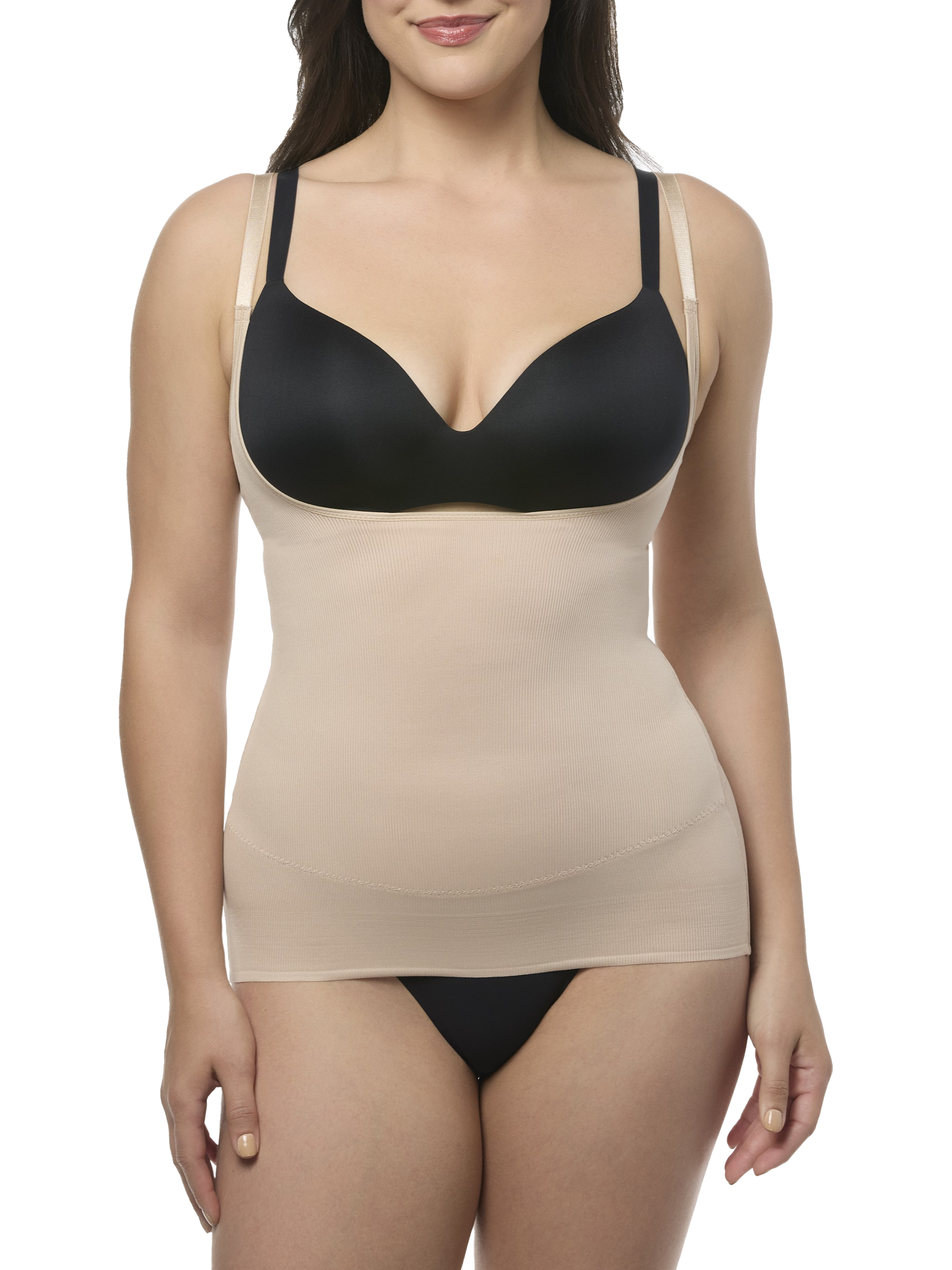 Woman wearing a black bra and beige camisole shapewear on a white background