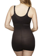 a woman wearing a black open-bust shaping bodysuit romper