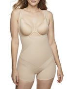 a woman wearing a beige open-bust shaping bodysuit romper