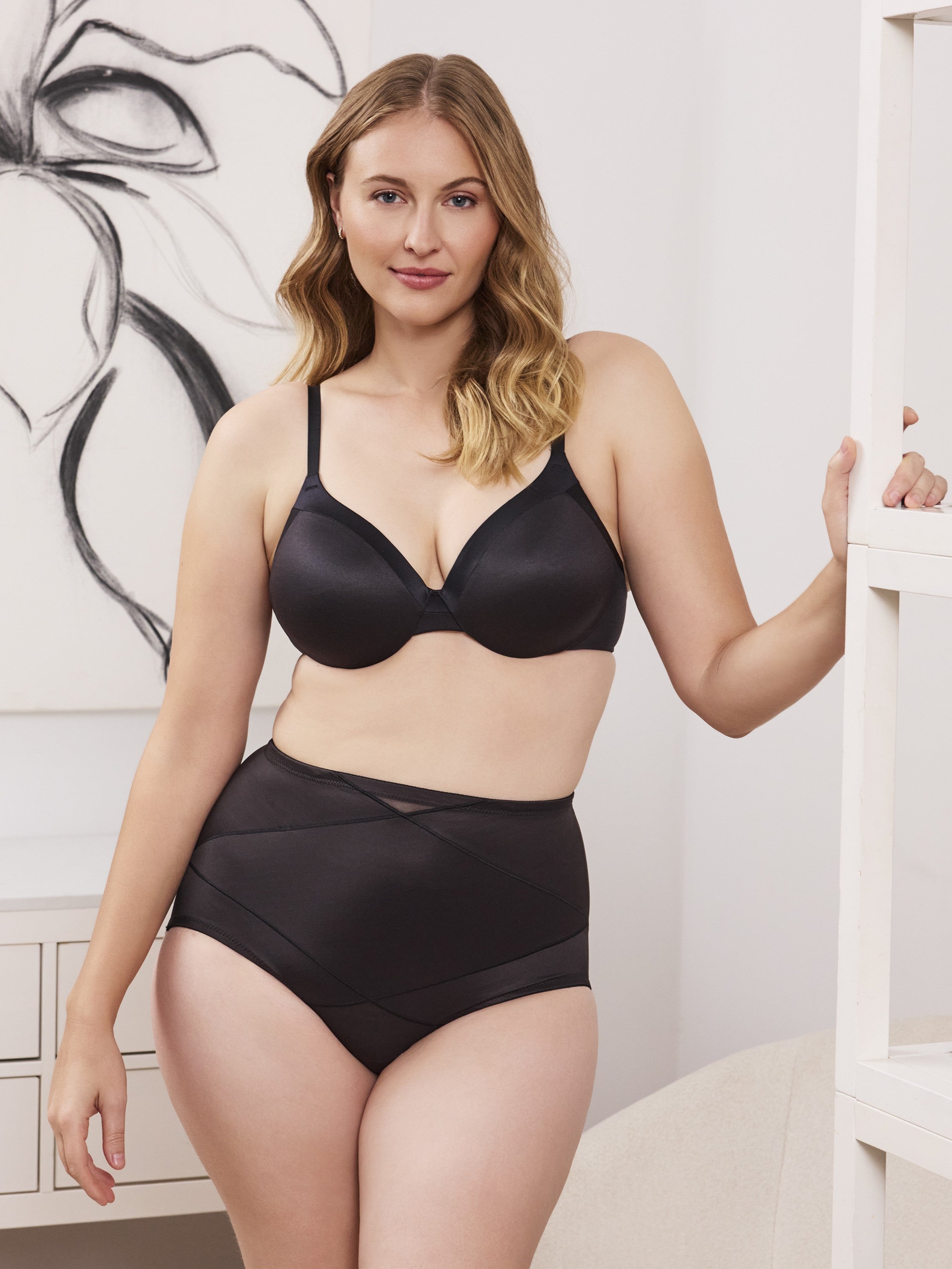 a woman wearing a black control top panty tummy control brief body shaper shapewear all-groups