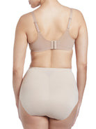 a woman wearing a beige shaping brief