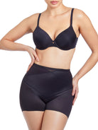 a woman wearing black tummy control shapewear shorts