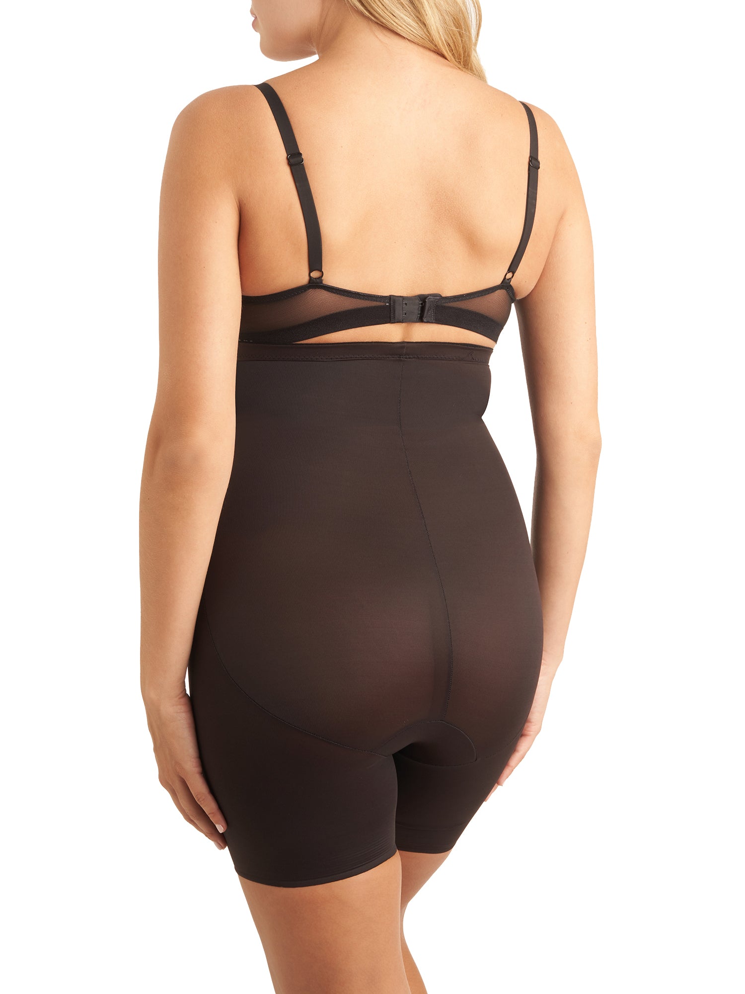 a woman wearing black high waisted tummy control shapewear shorts