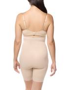 a woman wearing a beige high waisted body shaper short